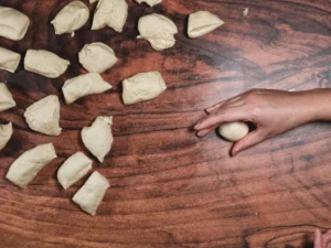 Rolling basic dinner rolls.